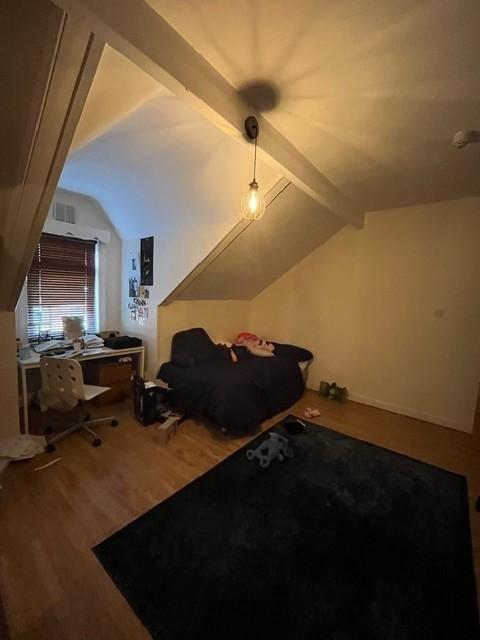 Cozy double bedroom with sloped ceiling, fitted...