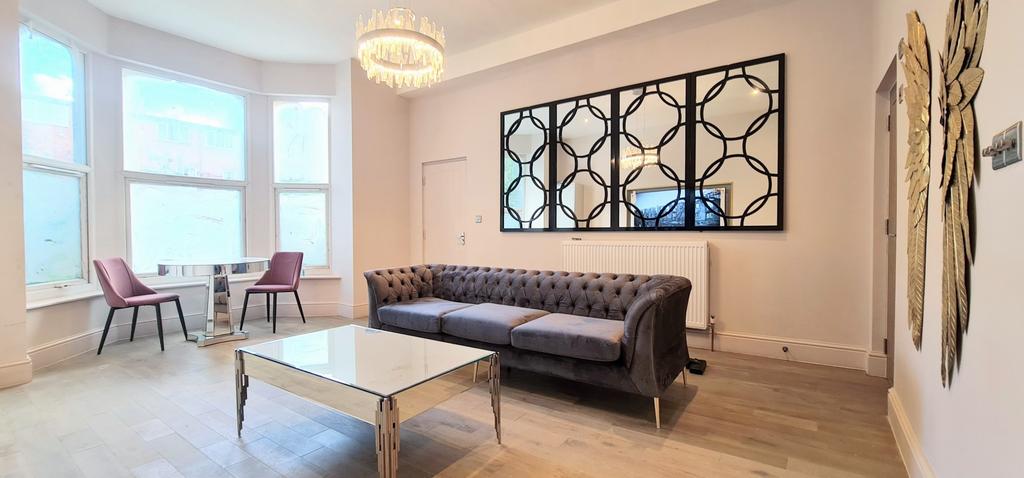 Bright, modern living room with a stylish tufte...