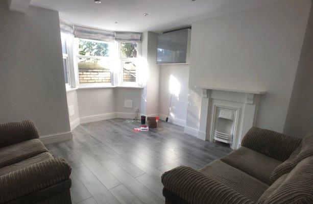 Bright, well-presented living room with wood-ef...