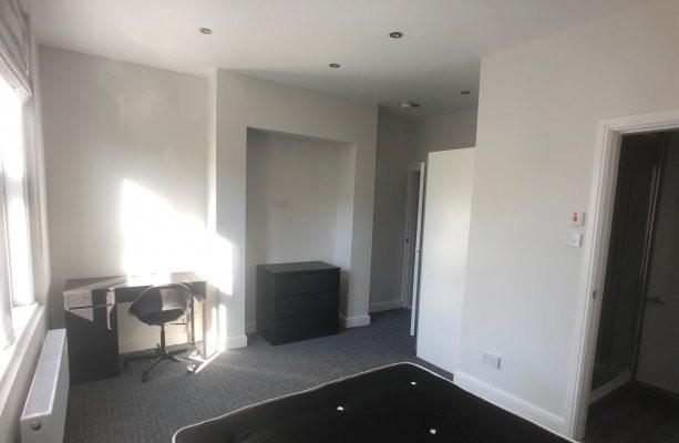 Bright, neutrally decorated double bedroom with...