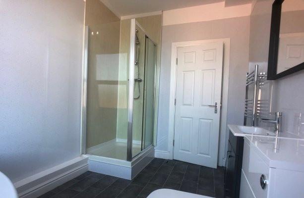 Bright, modern bathroom with a walk-in shower, ...