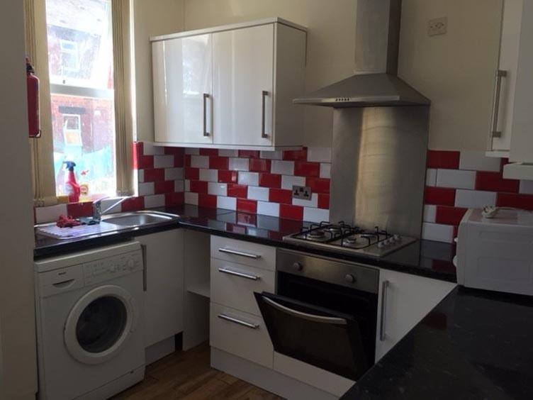 Bright fitted kitchen with modern white cabinet...