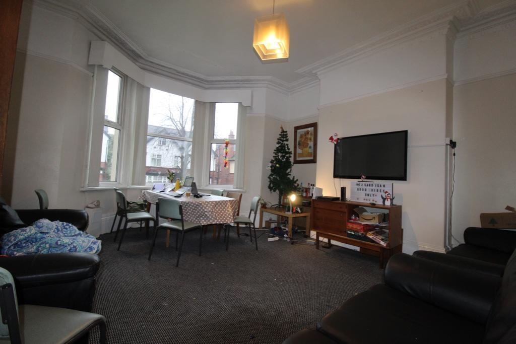 Spacious communal living room with a large bay ...