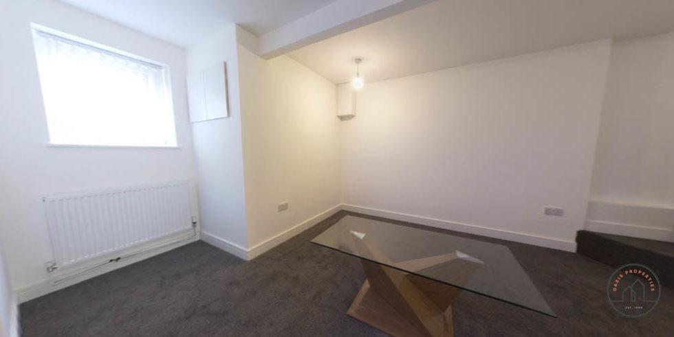 Bright, neutral bedroom with pale walls, a larg...