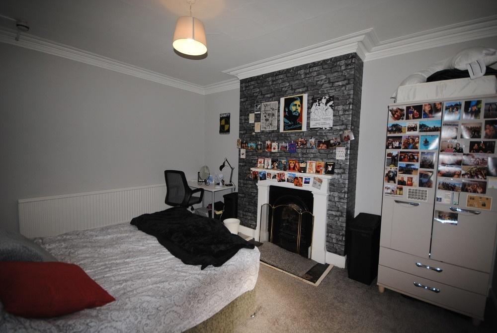 Brightly decorated double bedroom featuring a c...