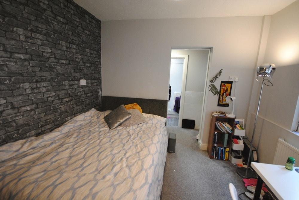 Well-presented double bedroom with a large bed,...