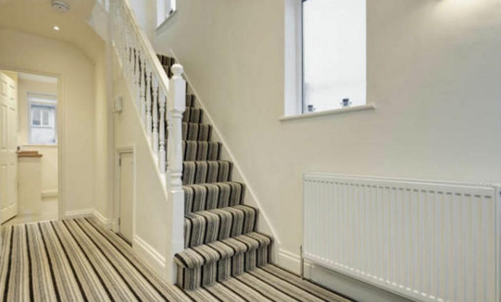 Bright, well-maintained entrance hallway with a...