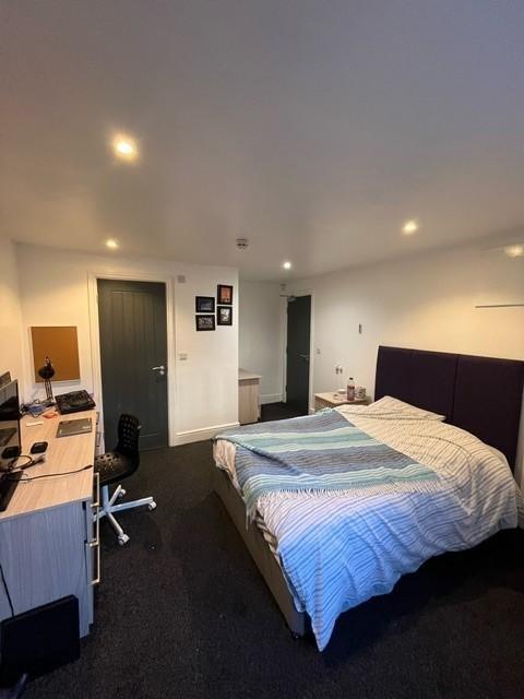 Bright, well-presented bedroom featuring a comf...