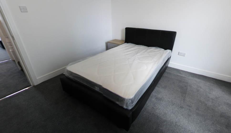 Bright, simply furnished double bedroom with a ...