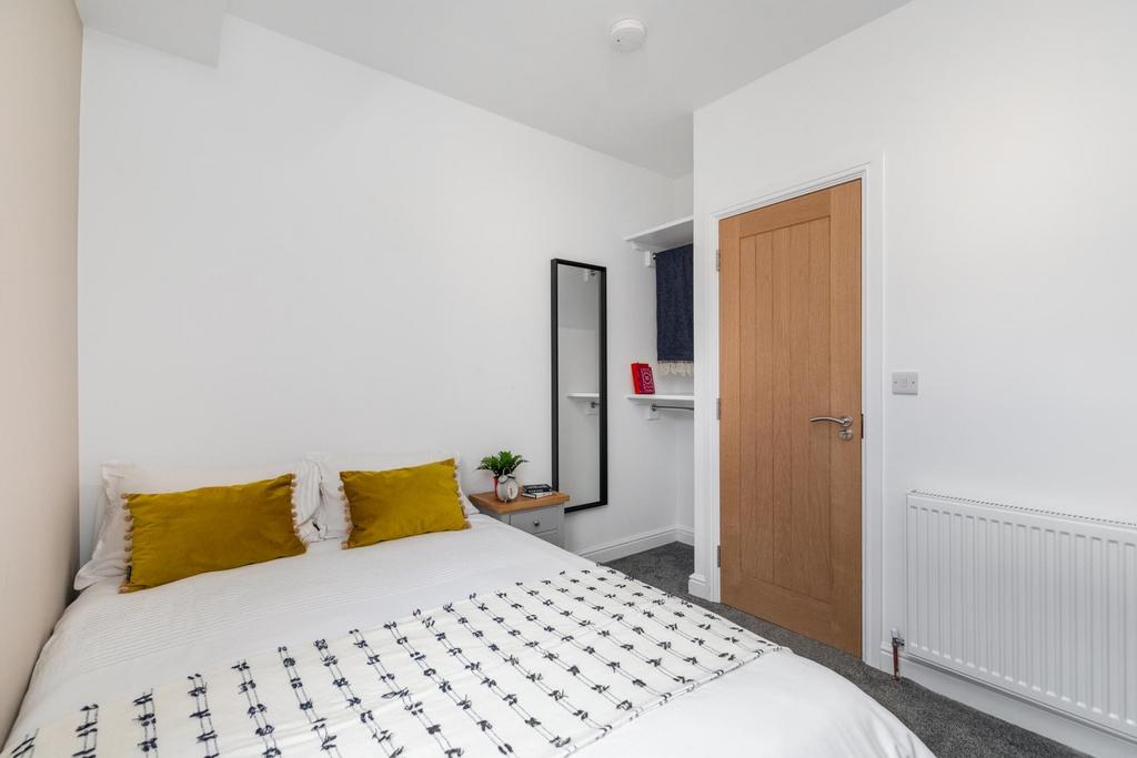 Well-presented double bedroom with a neatly mad...