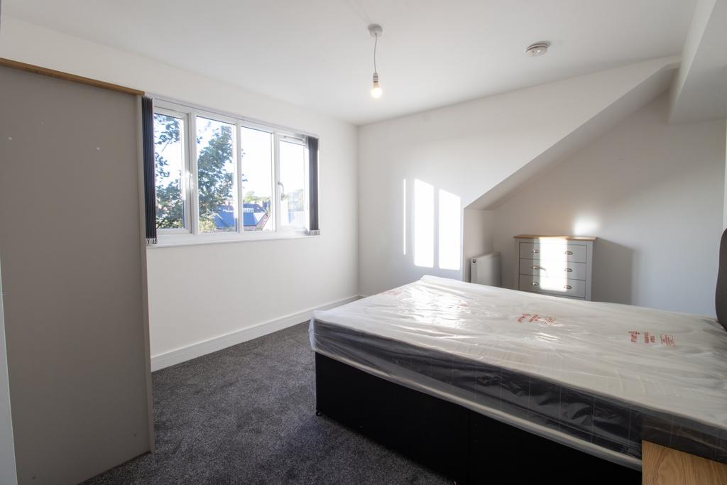 Bright, freshly-decorated bedroom with a large ...
