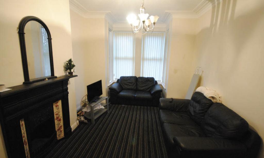 Bright, neutrally decorated living room with la...