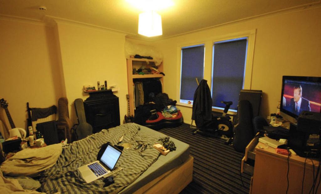 Warm-toned double bedroom with a double bed, de...
