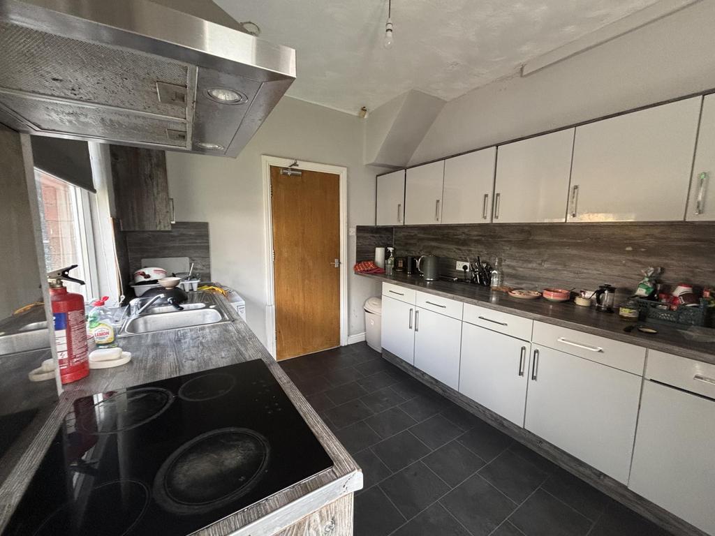 Bright galley-style kitchen with long runs of w...