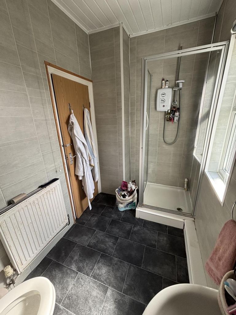 Bright, modern bathroom with a walk-in shower, ...