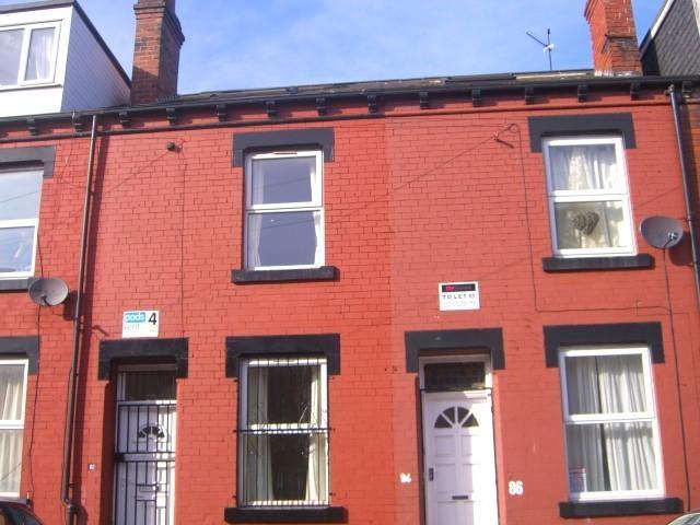 Red-brick terraced house with a neat frontage, ...