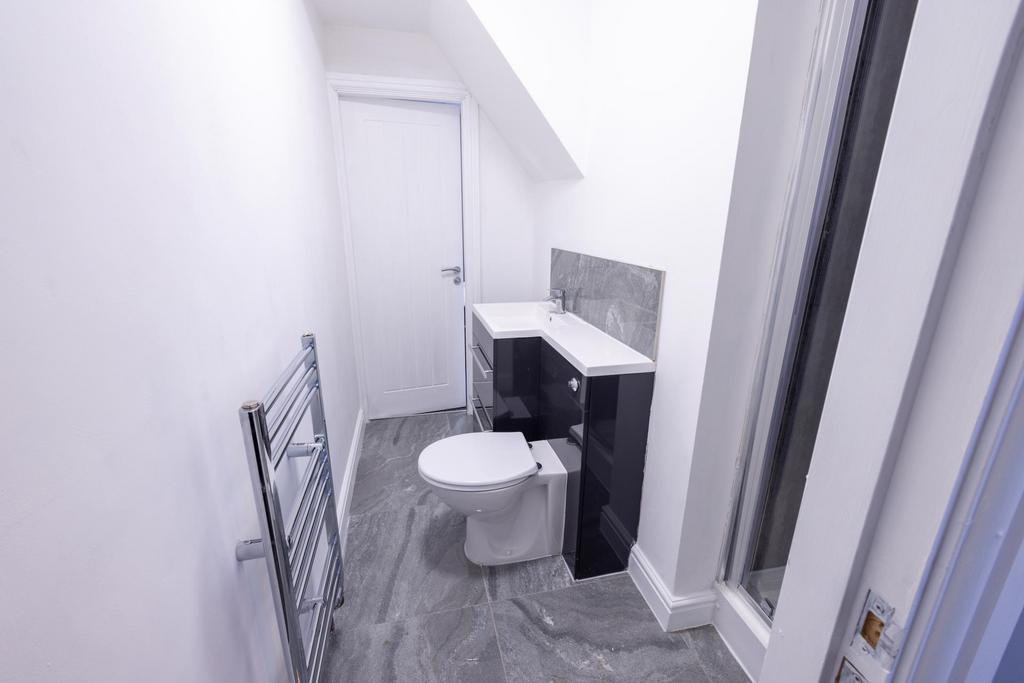 Neat modern bathroom with grey tile flooring, w...