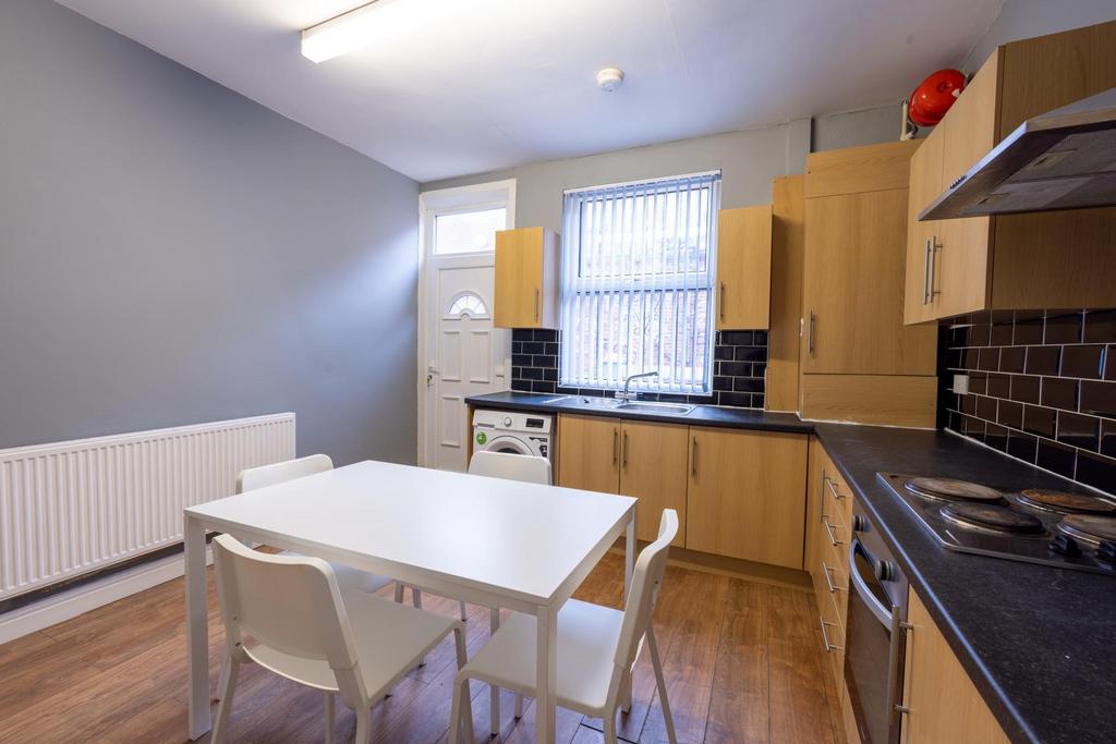 Bright modern kitchen with light wood cabinets,...