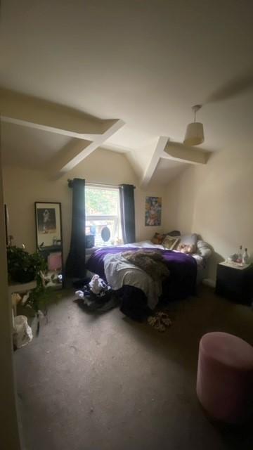 Bright bedroom with a double bed positioned ben...