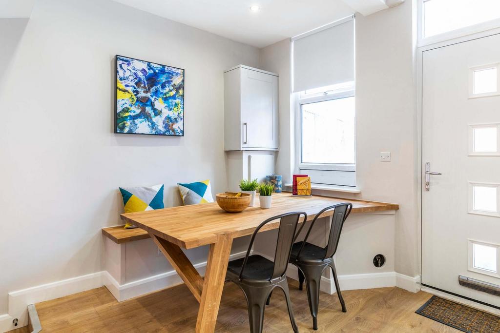 Bright, modern eat-in kitchen area with a woode...