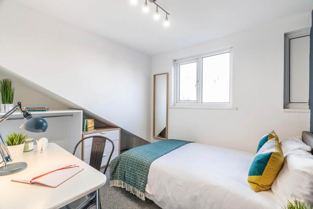 Bright, neatly presented bedroom with a comfort...