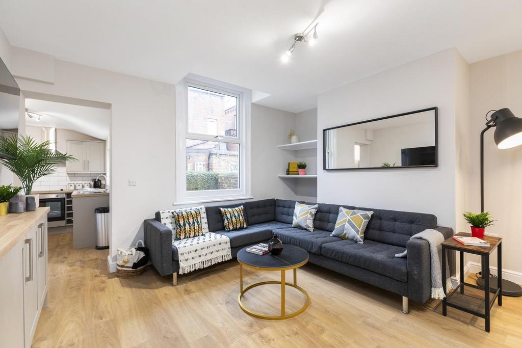 Bright, modern living area featuring a large L-...