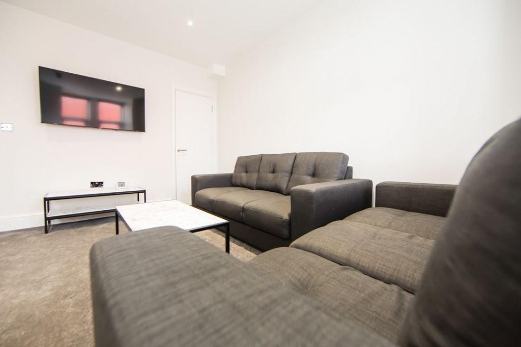 Bright, neutral living room with two comfortabl...