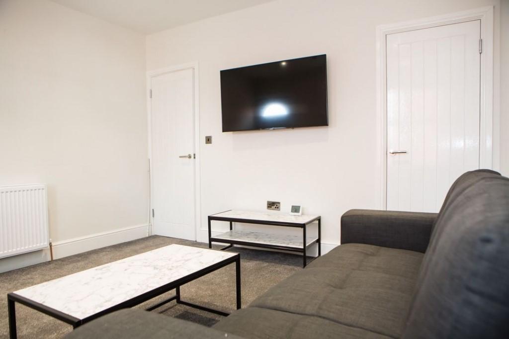 Bright, modern living room with a wall-mounted ...