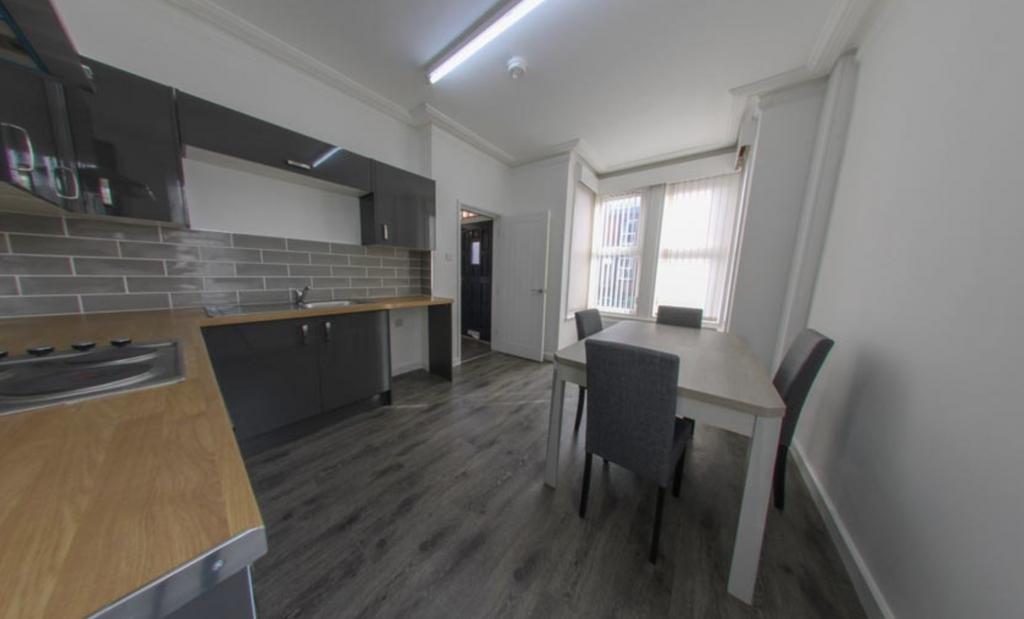 Bright modern kitchen with dark wood-effect flo...