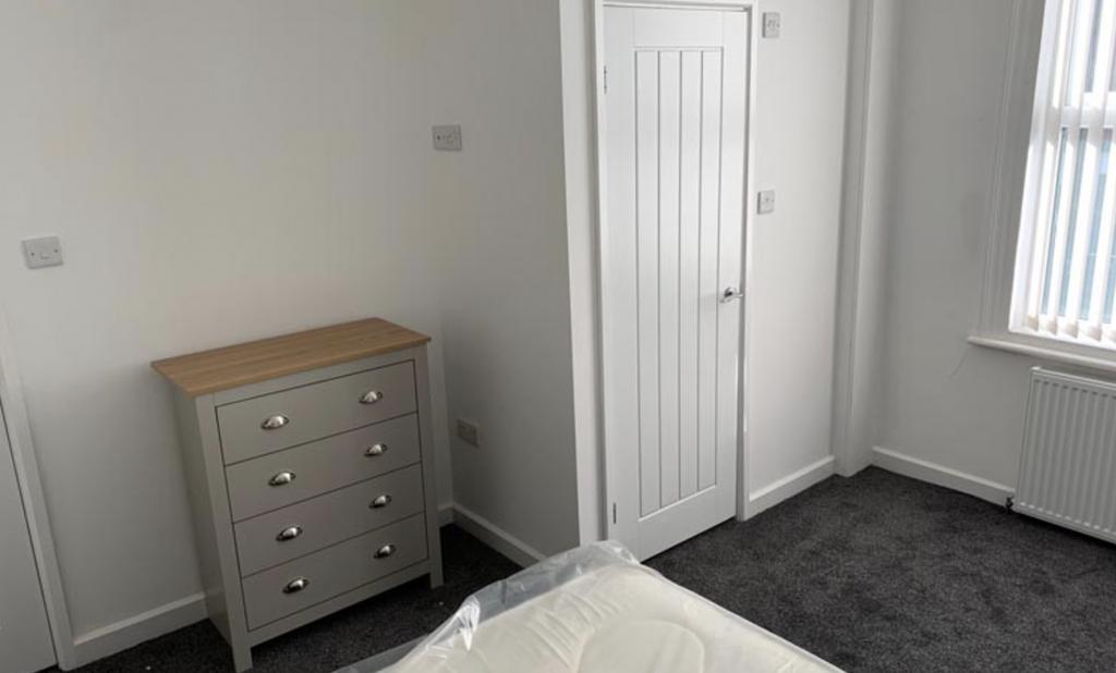 Neat, neutral double bedroom with fitted storag...