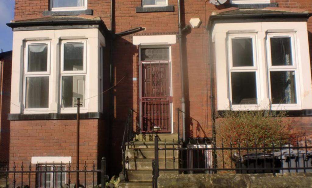 Red-brick terraced house with bay windows and a...