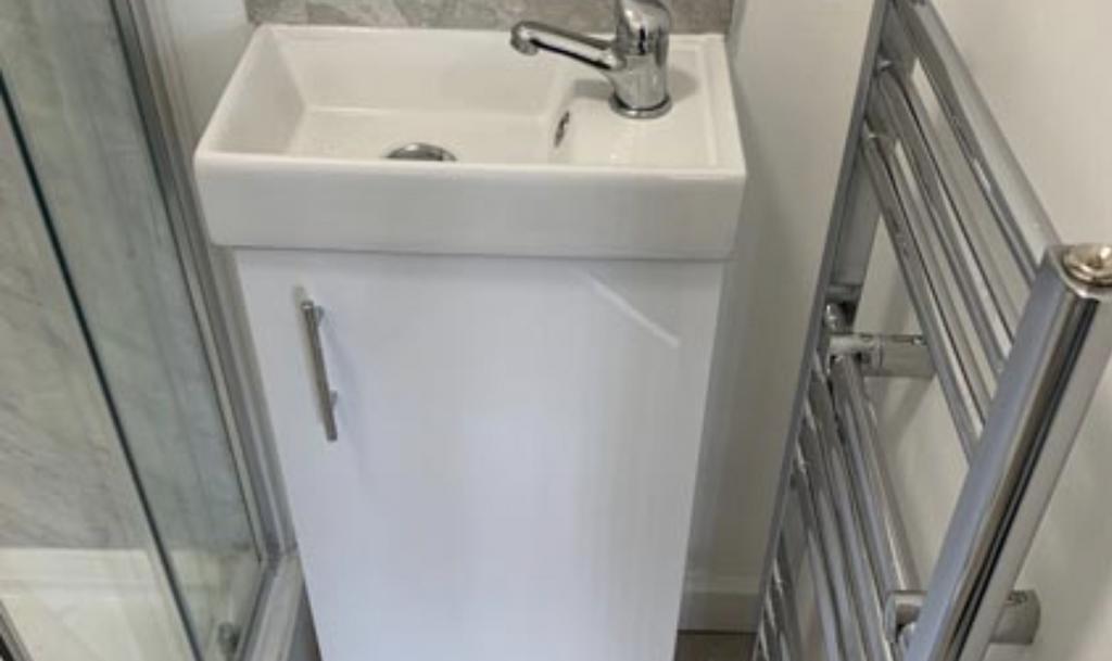 Compact modern bathroom sink and vanity unit be...