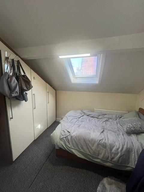 Cozy attic double bedroom with a skylight windo...