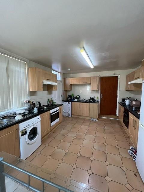Bright, well-equipped kitchen with ample storag...