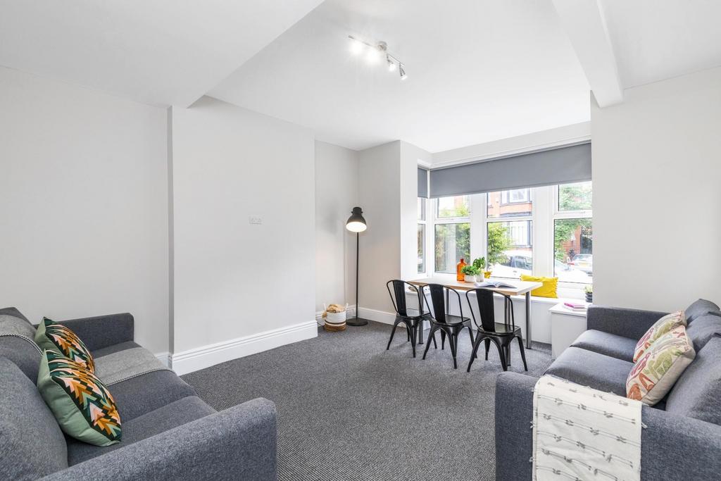 Bright, modern living space with two comfortabl...