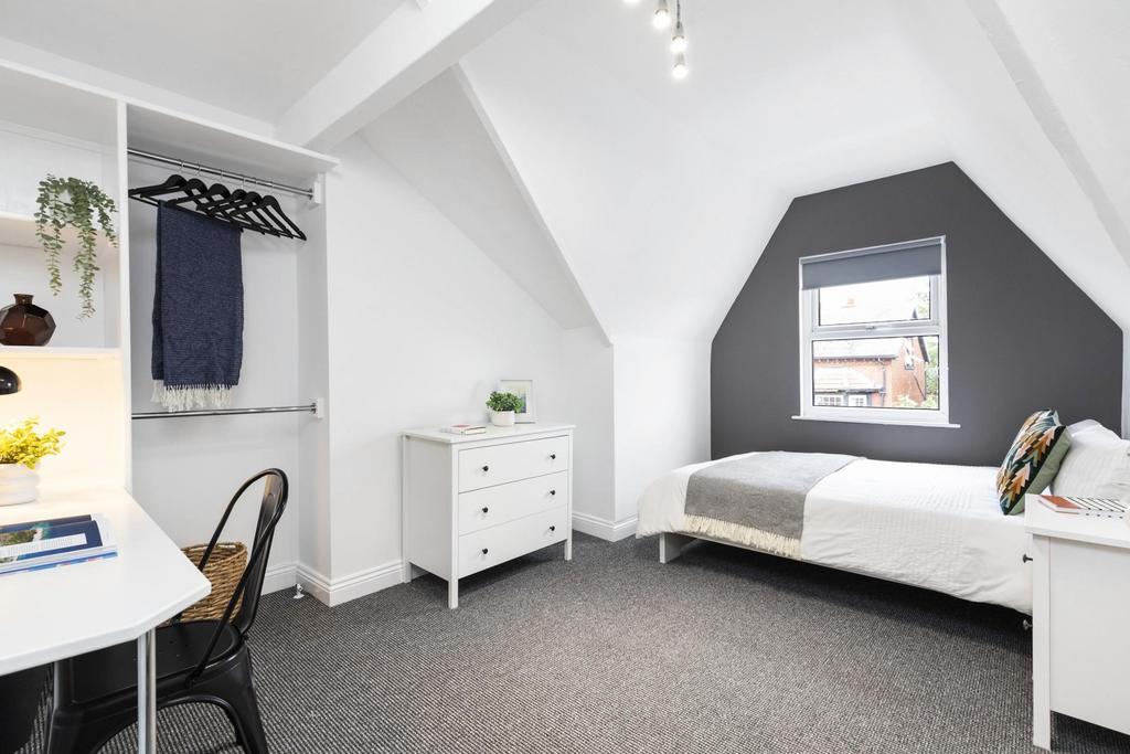 Bright, freshly decorated attic bedroom with a ...