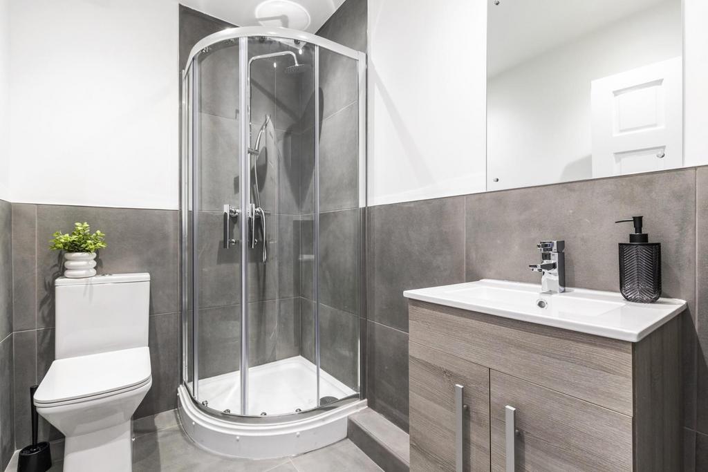 Modern, well-maintained bathroom with a corner ...