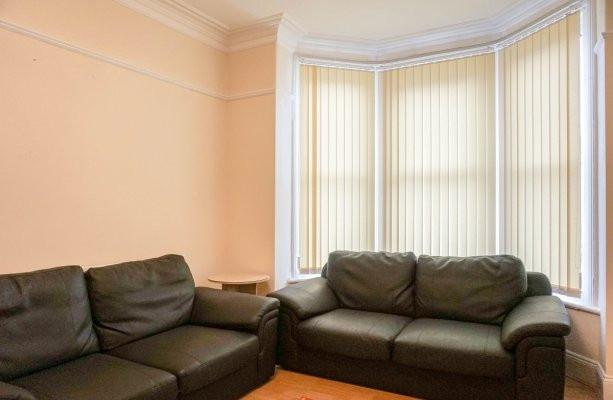 Bright, well-presented living room with a large...
