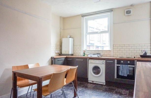 Bright kitchen with a dining table and four cha...