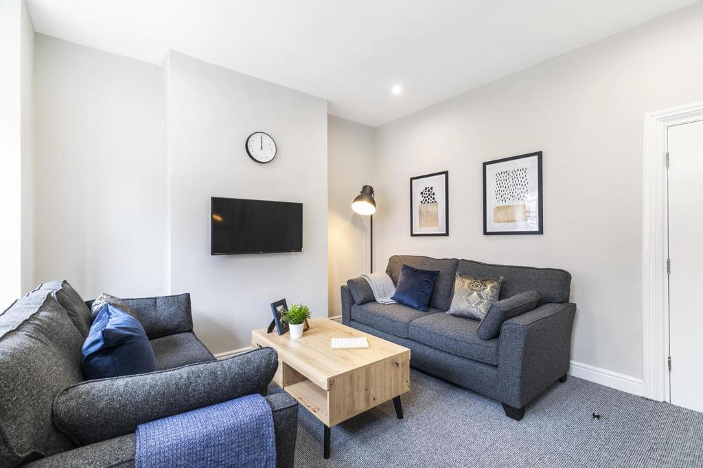 Bright, contemporary living room with two comfo...