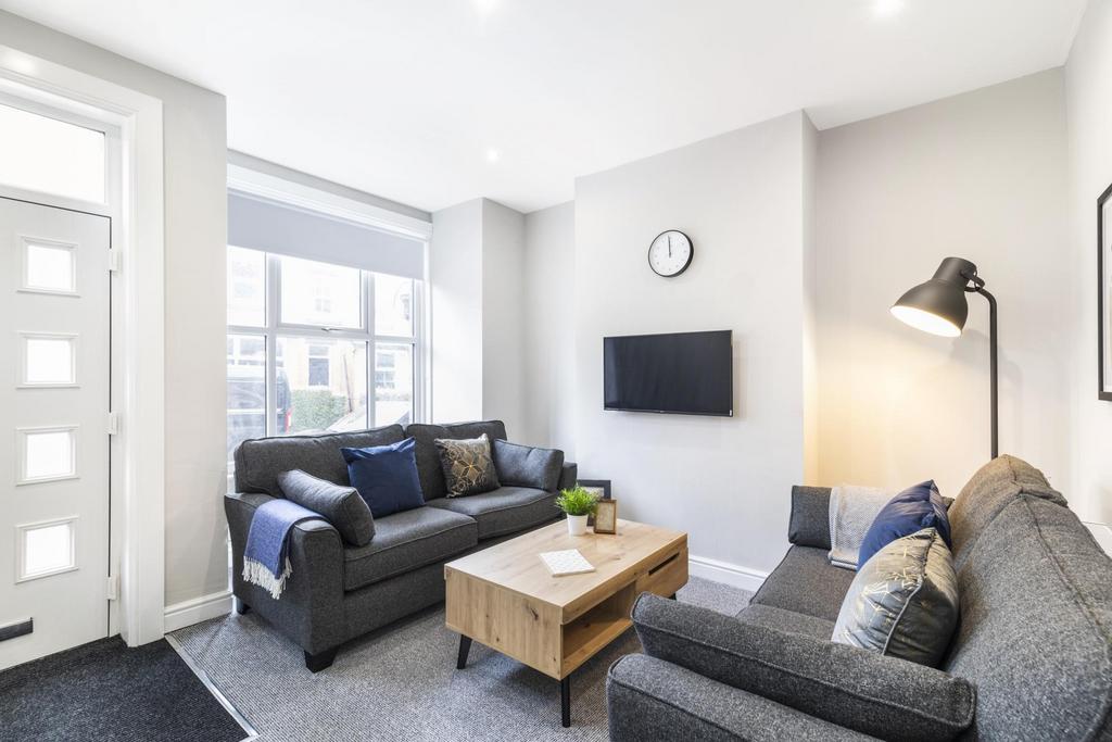 Bright, contemporary living room with two comfo...