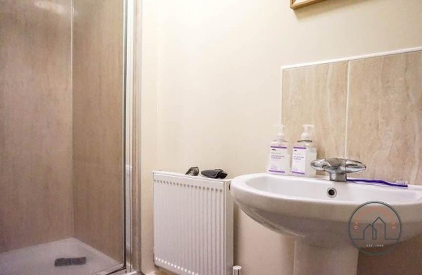 Bright, modern bathroom with walk-in shower, pe...