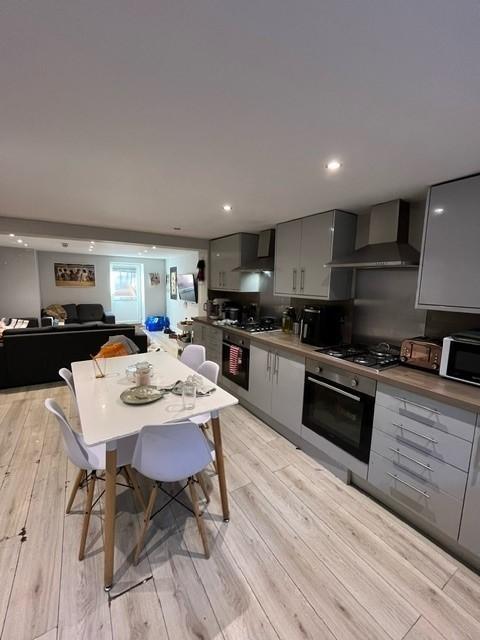 Modern open-plan kitchen and living area with s...