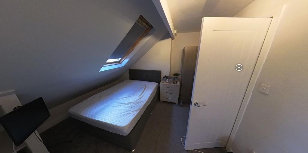 Neat attic bedroom with a double bed, skylight ...