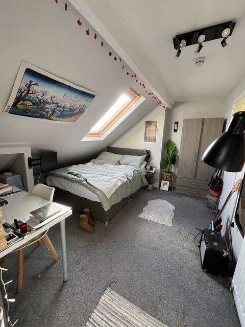 Bright attic double bedroom with a double bed b...