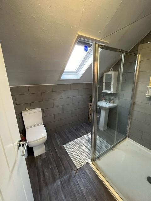 Bright, modern bathroom with a large walk-in sh...