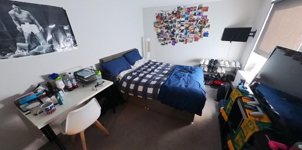 Bright, neatly arranged double bedroom with a c...