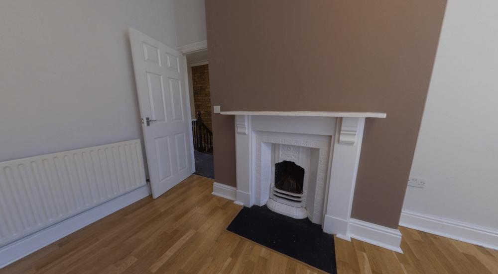 Bright bedroom with wooden floors, a decorative...