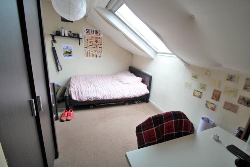 Bright attic-style double bedroom with a skylig...