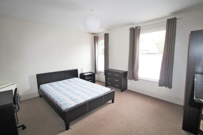 Bright, neutrally decorated double bedroom with...